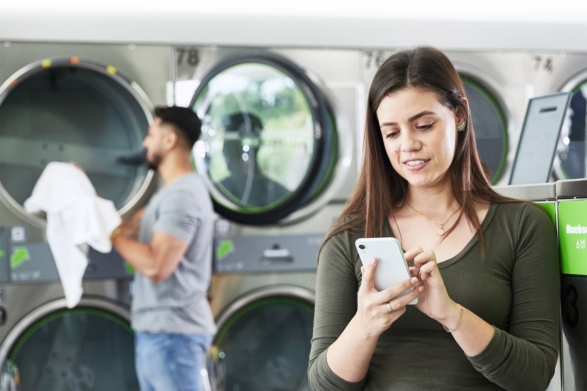 Female laundromat customer using Huebsch Phone App